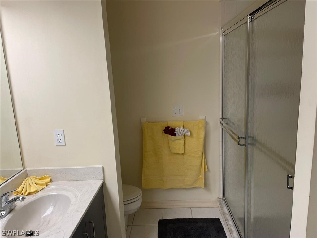 690 Morning Mist Lane Lehigh Acres, FL 33974 - Photo 15 of 20 a bathroom with a sink toilet and shower