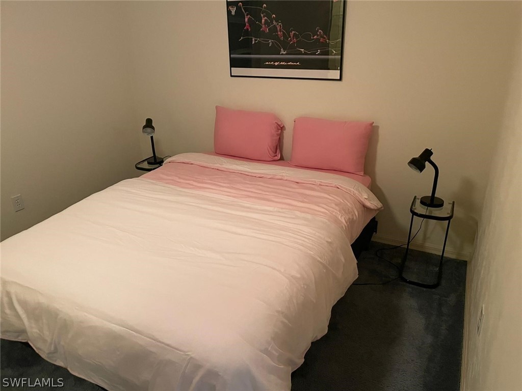 690 Morning Mist Lane Lehigh Acres, FL 33974 - Photo 16 of 20 a bed sitting in a bedroom next to a window