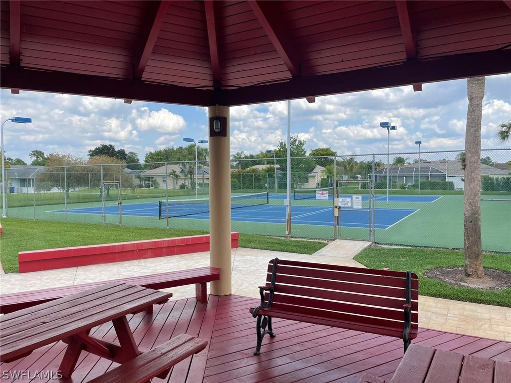 690 Morning Mist Lane Lehigh Acres, FL 33974 - Photo 20 of 20 a view of a park with wooden floor and a table