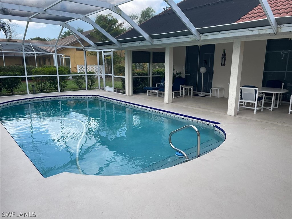 690 Morning Mist Lane Lehigh Acres, FL 33974 - Photo 3 of 20 a view of a swimming pool with outdoor seating