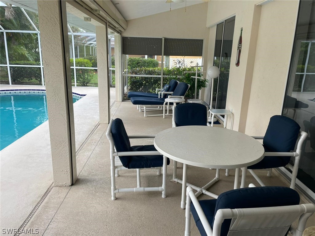 690 Morning Mist Lane Lehigh Acres, FL 33974 - Photo 4 of 20 a outdoor dining space with furniture and a window