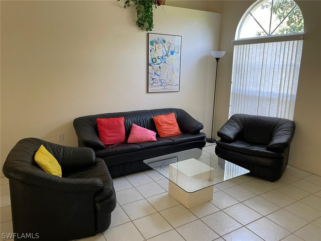690 Morning Mist Lane Lehigh Acres, FL 33974 - Photo 7 of 20 a living room with furniture and a window