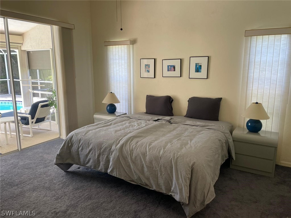 690 Morning Mist Lane Lehigh Acres, FL 33974 - Photo 8 of 20 a bedroom with a bed and glass window