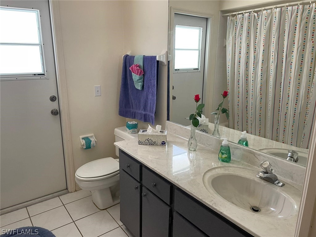 690 Morning Mist Lane Lehigh Acres, FL 33974 - Photo 10 of 20 a bathroom with a granite countertop sink and a mirror