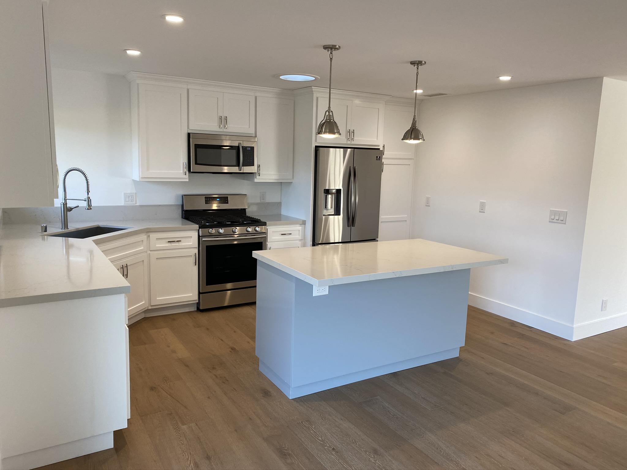 5160 Via Valverde Santa Barbara, CA 93111 - Photo 6 of 12 a large kitchen with stainless steel appliances a large counter top and wooden floors