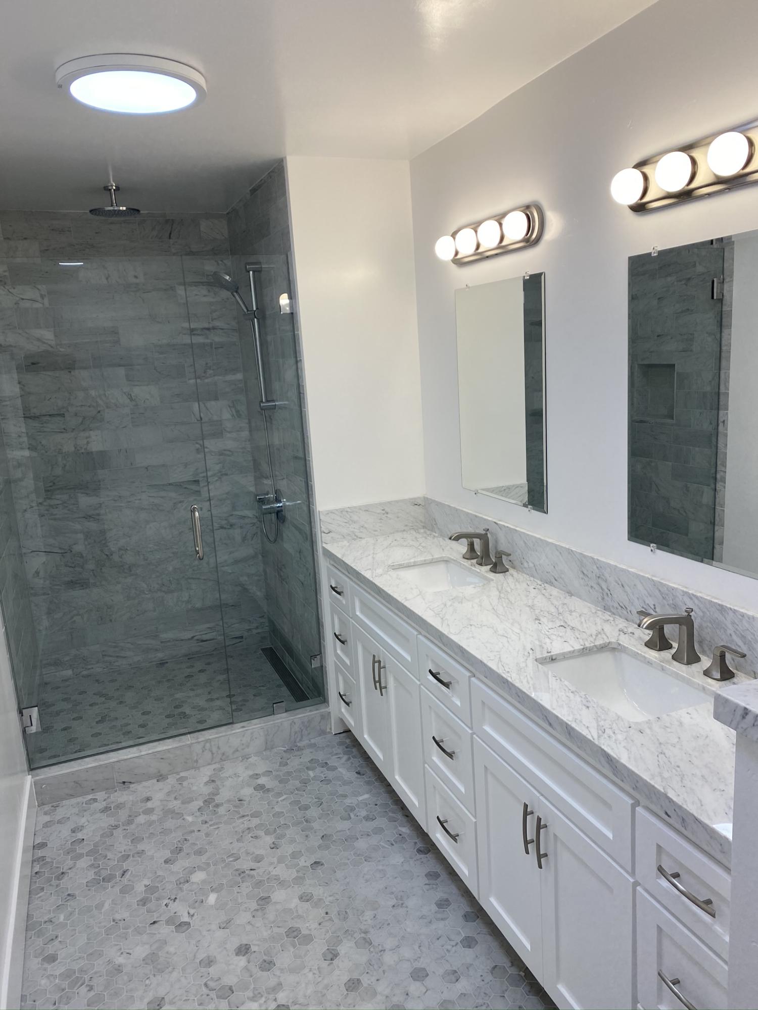 5160 Via Valverde Santa Barbara, CA 93111 - Photo 7 of 12 a bathroom with a granite countertop sink a mirror and a shower