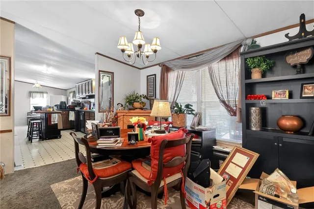 a view of a dining room with furniture and a chandelier