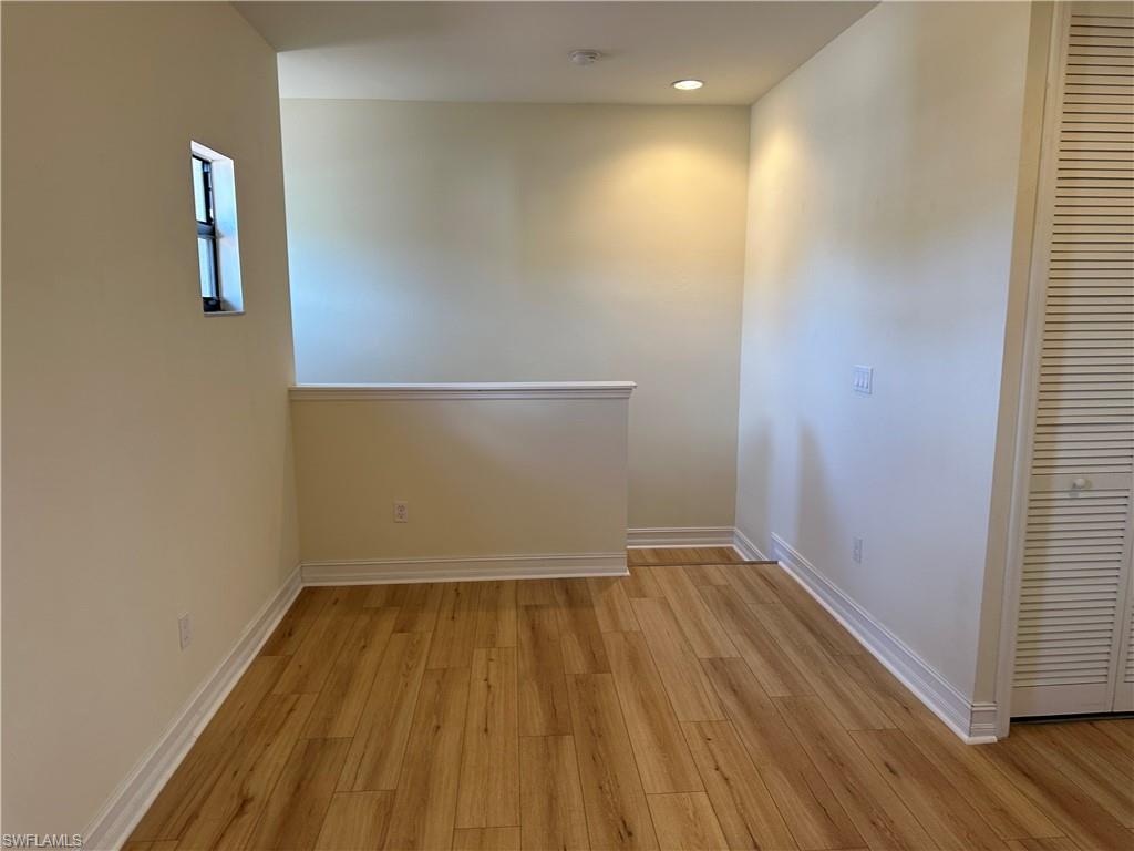 7776 Bristol Circle Naples, FL 34120 - Photo 6 of 6 Unfurnished room with light wood-type flooring and recessed lighting