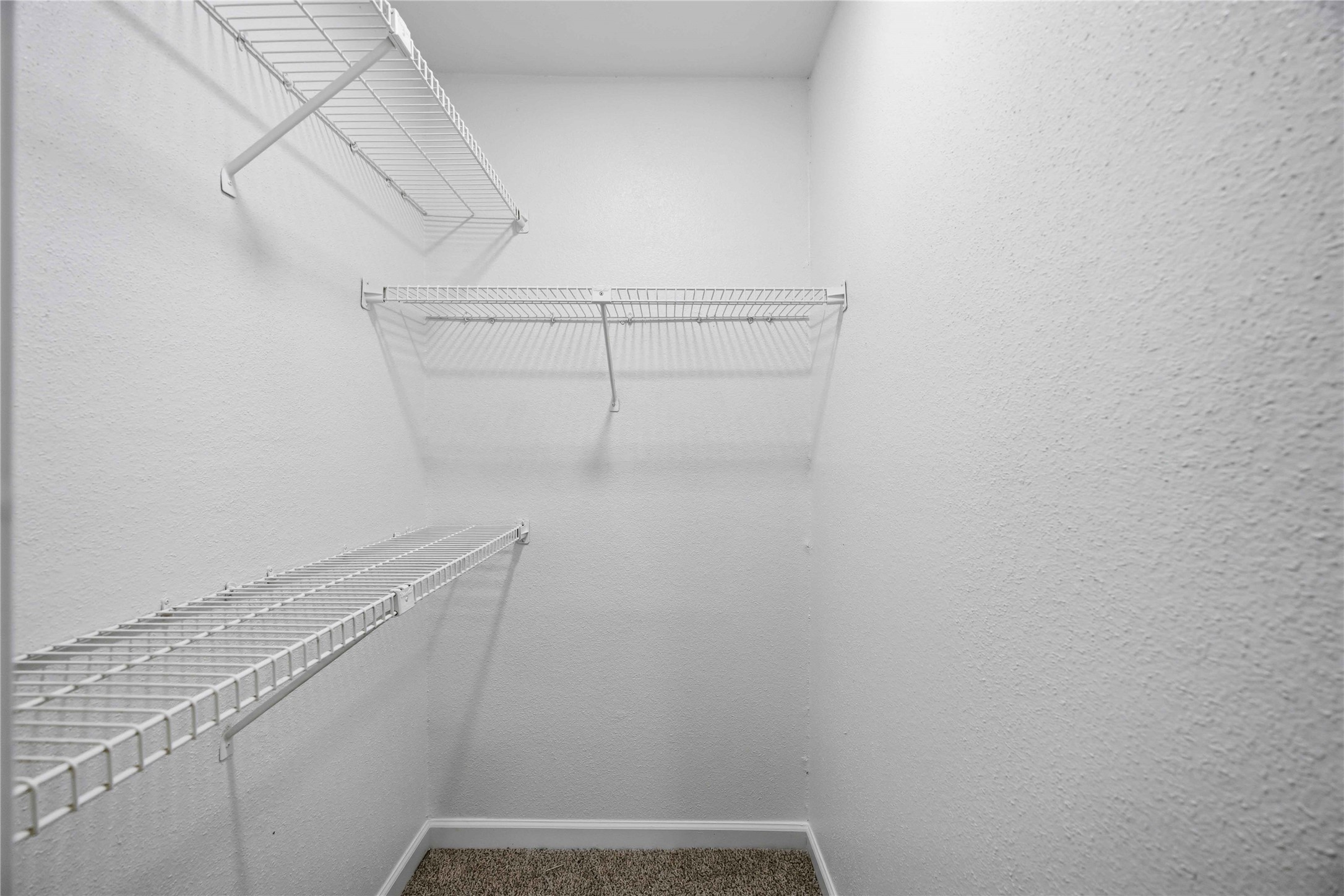 12703 Redfern Drive Houston, TX 77048 - Photo 16 of 28 Spacious walk-in closet with built-in shelving—providing ample storage and organization potential to suit your lifestyle needs.