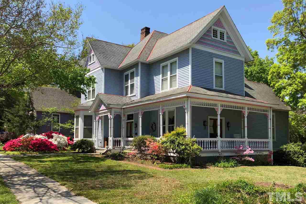 325 Polk Street Raleigh, NC 27604 - Photo 1 of 25 a front view of a house with a yard and potted plants