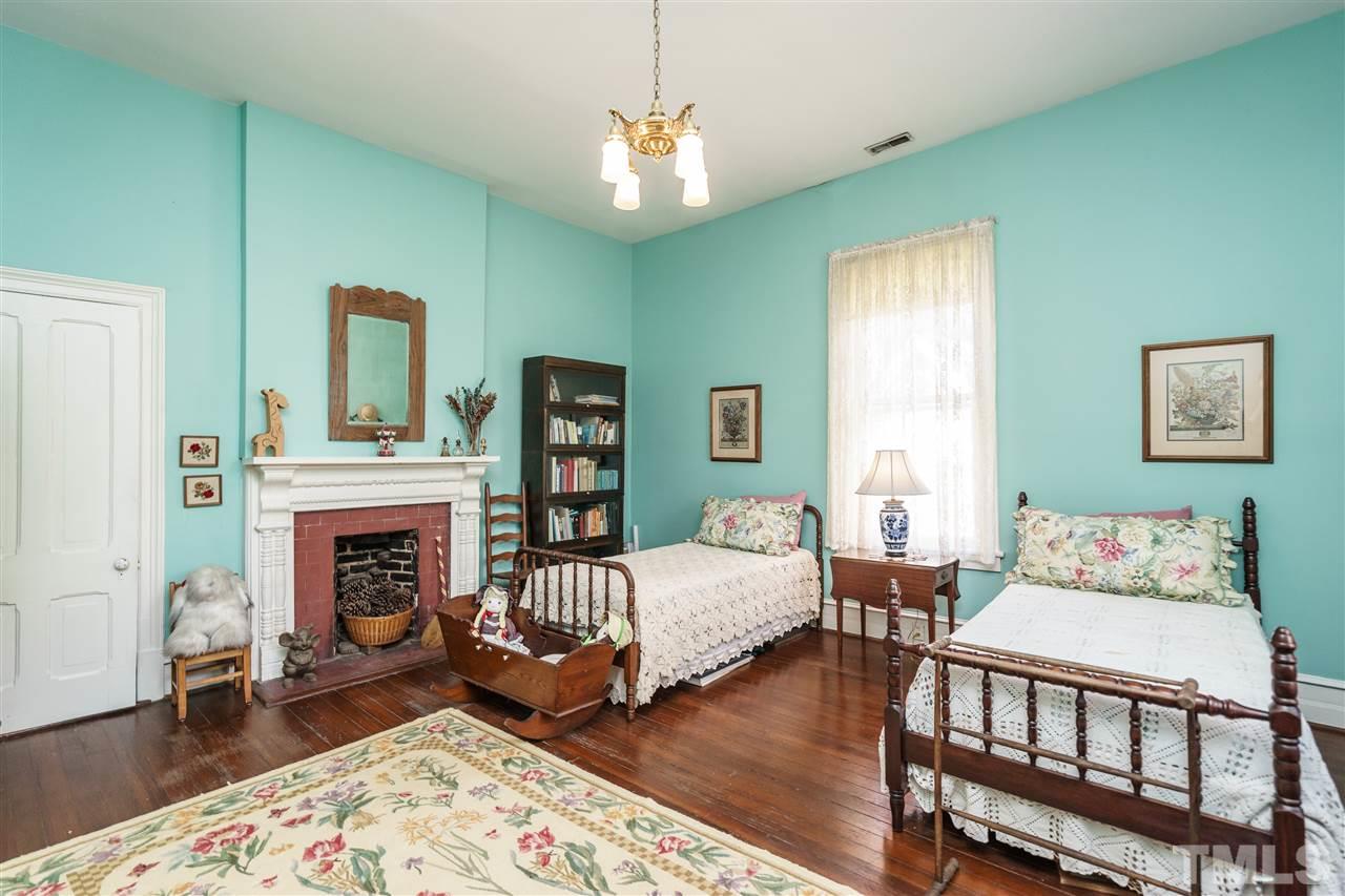 325 Polk Street Raleigh, NC 27604 - Photo 22 of 25 a bedroom with furniture and a fireplace