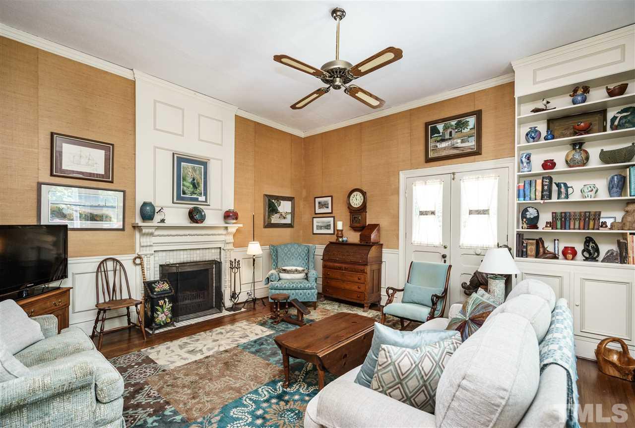 325 Polk Street Raleigh, NC 27604 - Photo 7 of 25 a living room with furniture a fireplace and a window