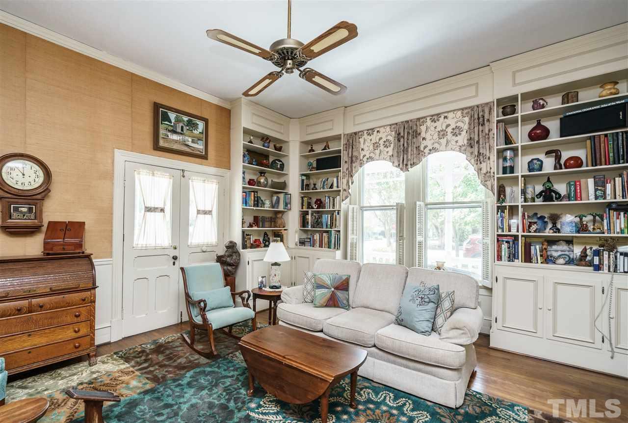 325 Polk Street Raleigh, NC 27604 - Photo 8 of 25 a living room with furniture a bookshelf and a window