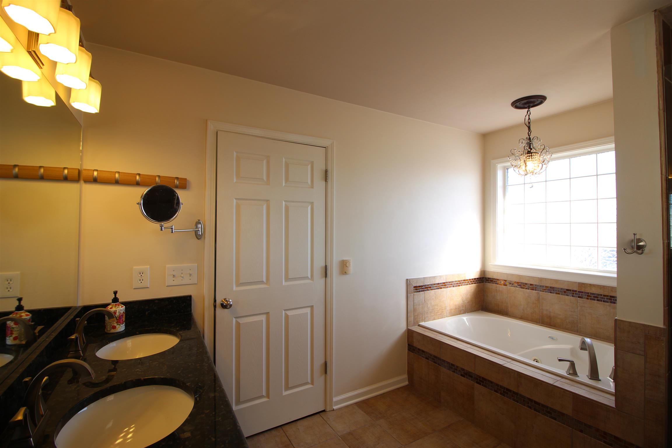 1605 Cut Off Road Murfreesboro, TN 37129 - Photo 23 of 30 Master bath features include: a garden tub with a lovely chandelier above it, large tile shower and granite double vanities. Keep your feet nice and warm on the HEATED tile flooring! :)