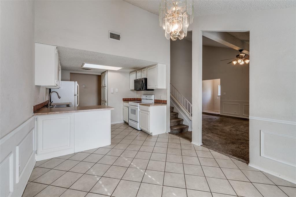 803 Canary Lane Mansfield, TX 76063 - Photo 11 of 25 a kitchen with a sink a stove and cabinets