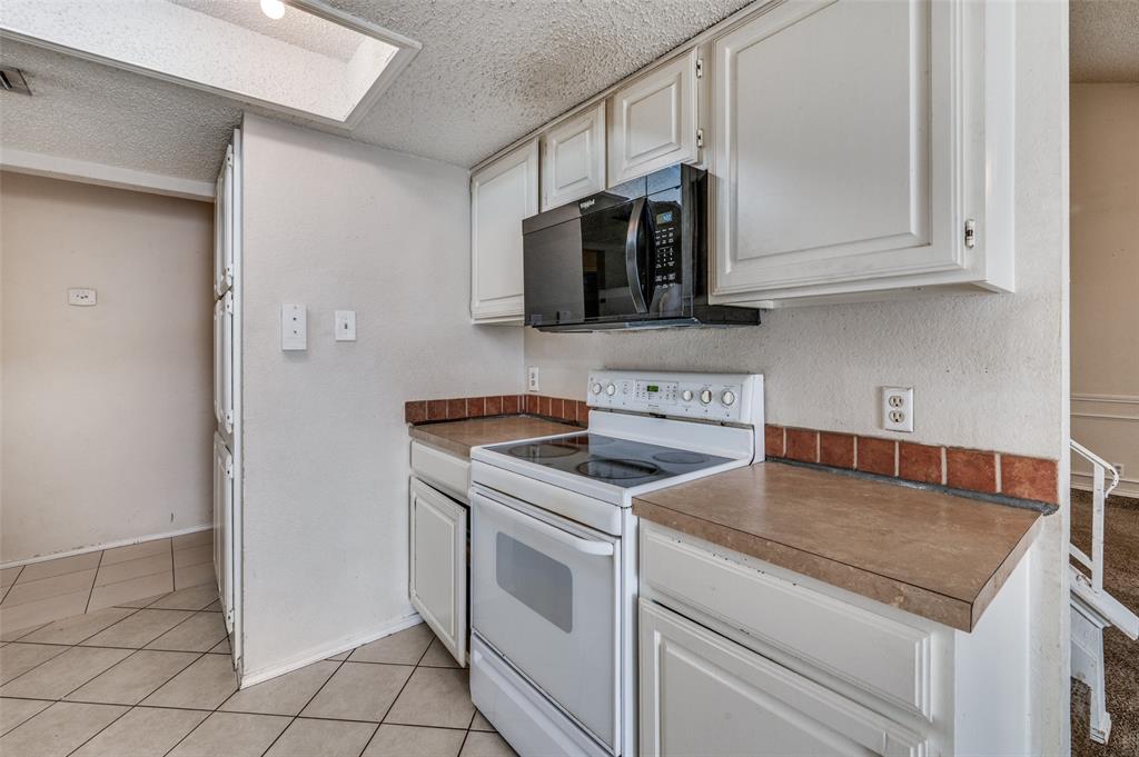 803 Canary Lane Mansfield, TX 76063 - Photo 12 of 25 a kitchen with stainless steel appliances granite countertop a stove a microwave and a sink