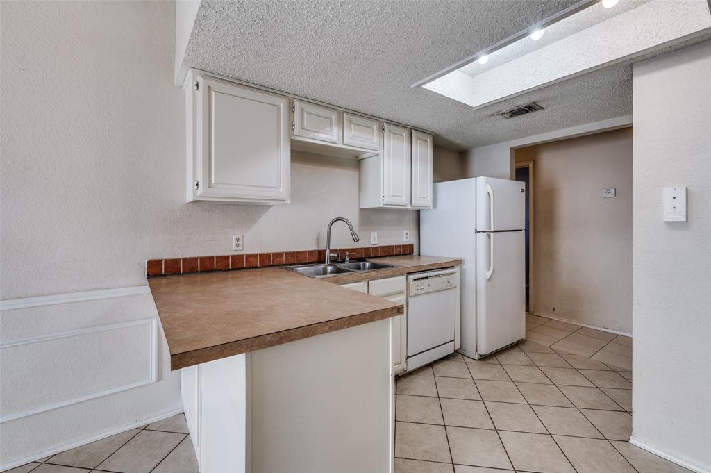 803 Canary Lane Mansfield, TX 76063 - Photo 13 of 25 a kitchen with a refrigerator sink stove and cabinets