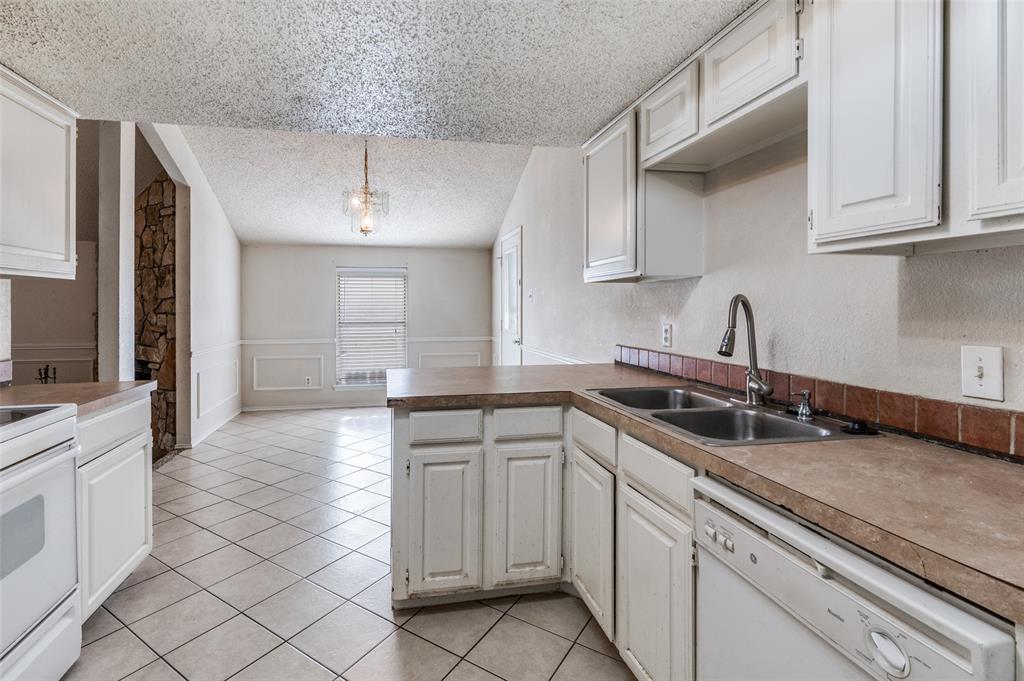 803 Canary Lane Mansfield, TX 76063 - Photo 14 of 25 a kitchen with a sink and cabinets