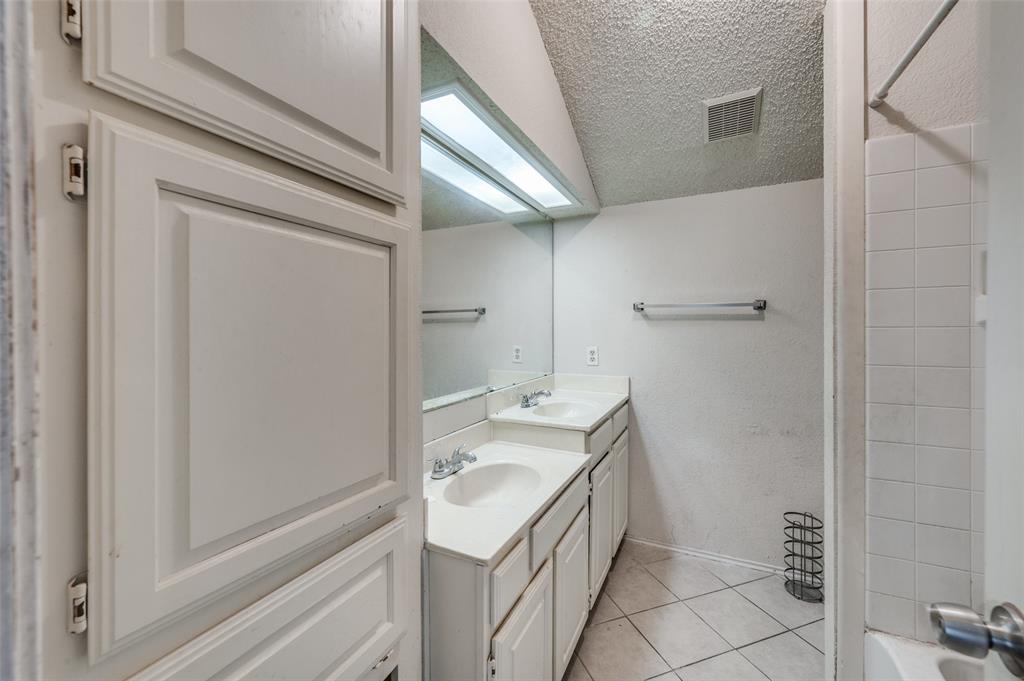 803 Canary Lane Mansfield, TX 76063 - Photo 16 of 25 a bathroom with a sink a toilet and shower