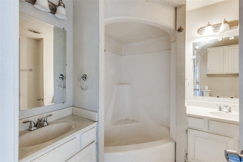 803 Canary Lane Mansfield, TX 76063 - Photo 23 of 25 a bathroom with a granite countertop sink a mirror a bathtub and shower