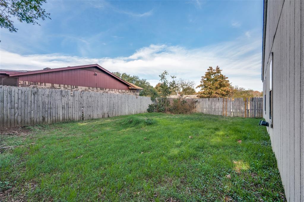 803 Canary Lane Mansfield, TX 76063 - Photo 25 of 25 a view of a backyard with a garden and wooden fence