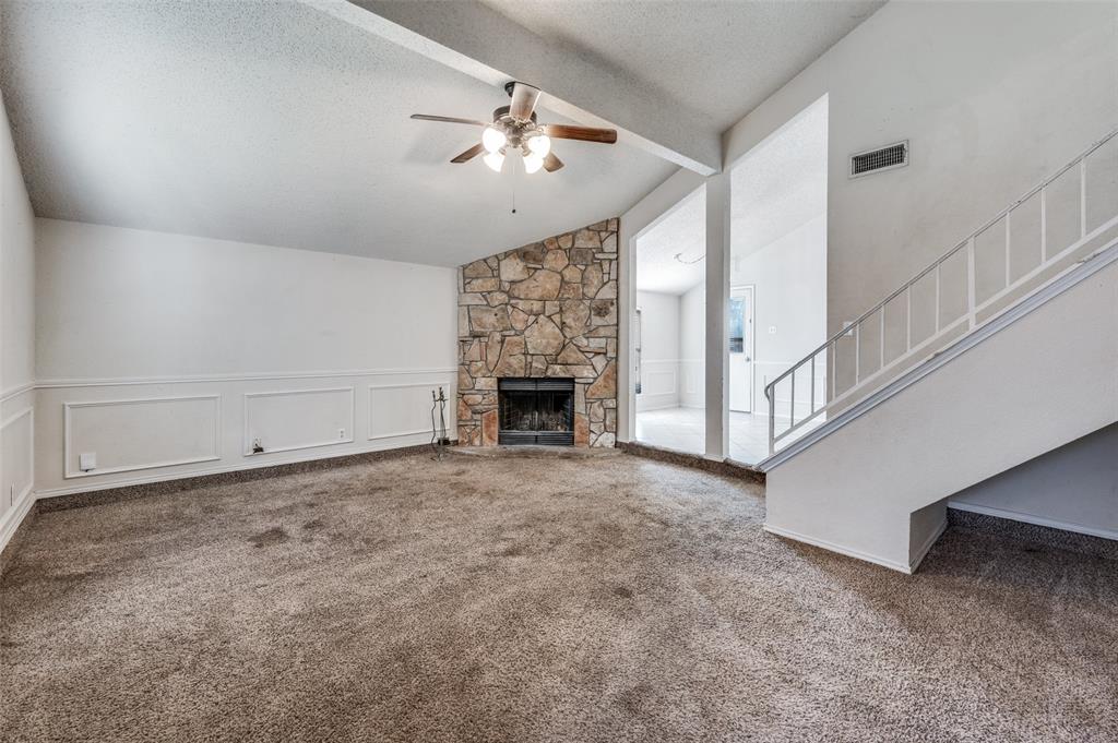 803 Canary Lane Mansfield, TX 76063 - Photo 4 of 25 en empty room with windows and fireplace