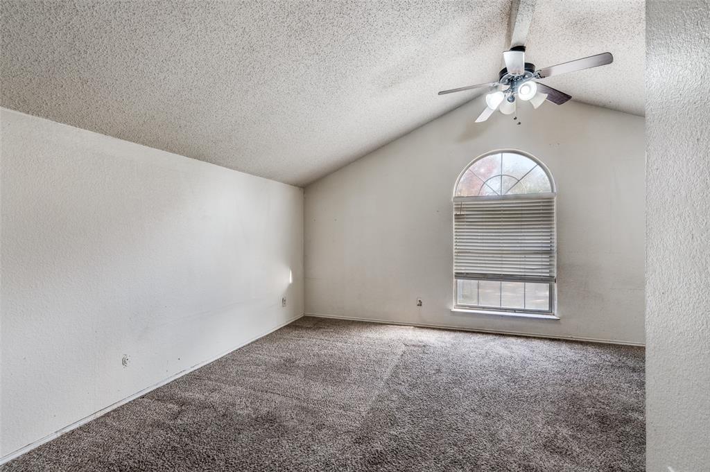 803 Canary Lane Mansfield, TX 76063 - Photo 7 of 25 an empty room with a chandelier fan and windows