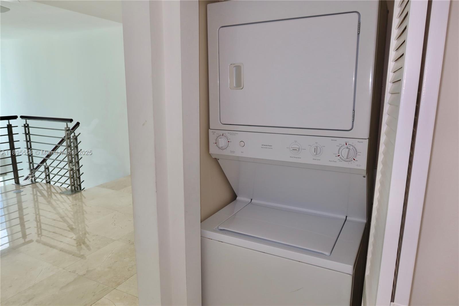 41 Southeast 5th Street, Unit 1611 Miami, FL 33131 - Photo 7 of 12 a utility room with dryer and washer