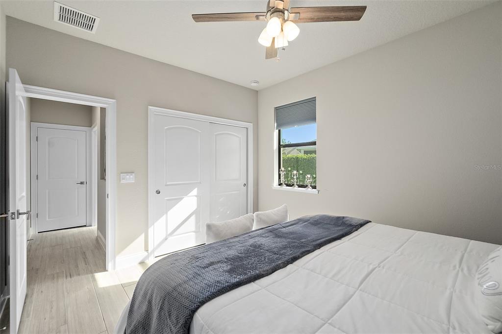 100 Seaside Pt Point Flagler Beach, FL 32136 - Photo 35 of 70 a bedroom with a large bed and a chandelier