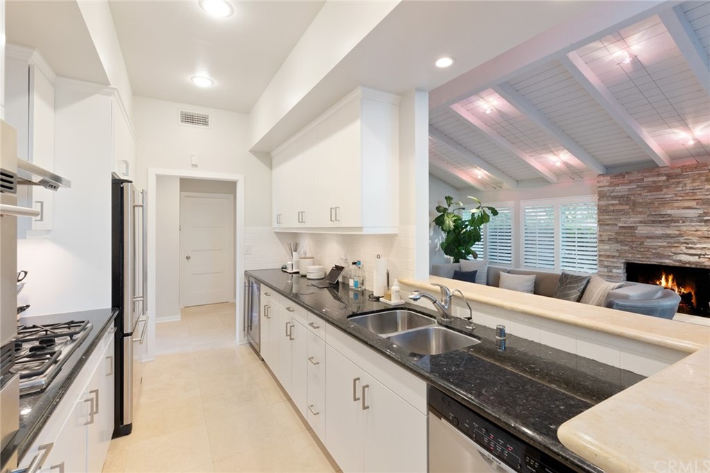 504 Avenida Largo Newport Beach, CA 92660 - Photo 18 of 36 a kitchen with stainless steel appliances sinks a stove and a refrigerator