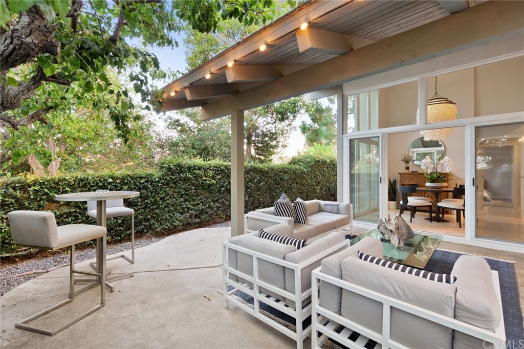 504 Avenida Largo Newport Beach, CA 92660 - Photo 21 of 36 a view of a patio with couches table and chairs and potted plants