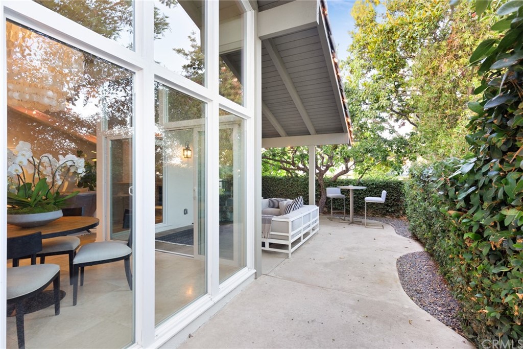 504 Avenida Largo Newport Beach, CA 92660 - Photo 22 of 36 a view of a patio with table and chairs and potted plants