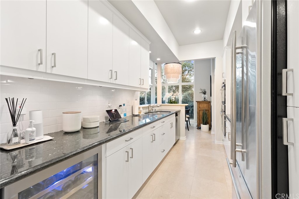 504 Avenida Largo Newport Beach, CA 92660 - Photo 24 of 36 a kitchen with granite countertop a sink stainless steel appliances and cabinets