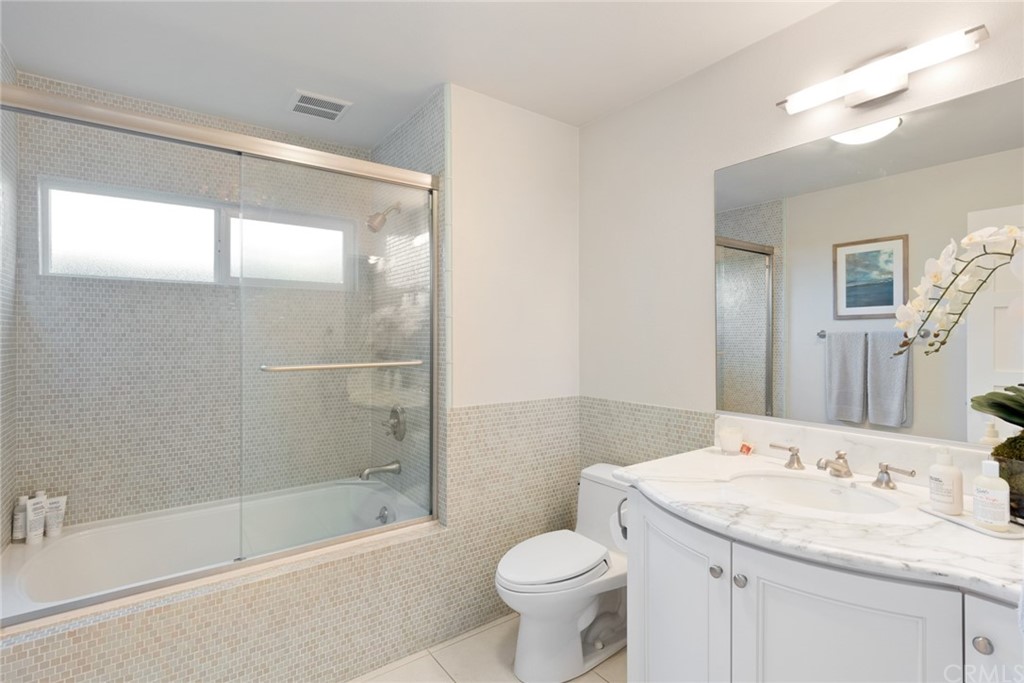 504 Avenida Largo Newport Beach, CA 92660 - Photo 32 of 36 a bathroom with a granite countertop sink toilet and shower