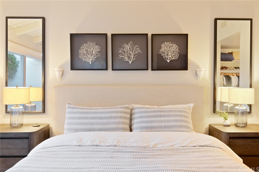 504 Avenida Largo Newport Beach, CA 92660 - Photo 5 of 36 a bedroom with a large bed and a chandelier