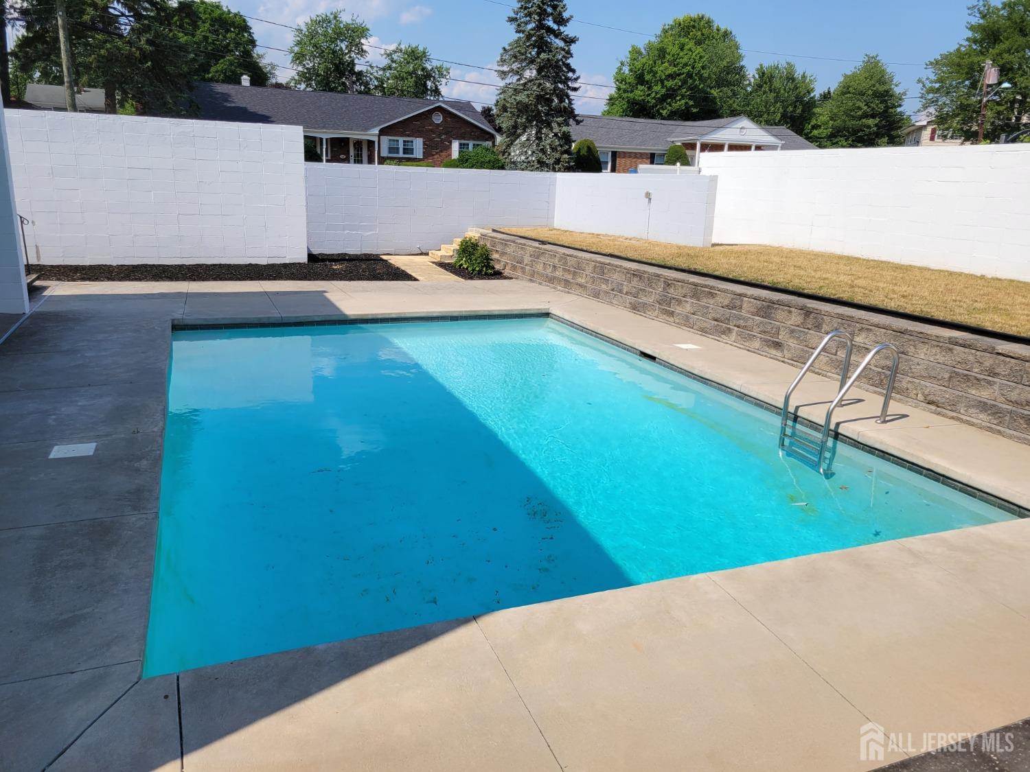 123 Risoli Terrace South Plainfield, NJ 07080 - Photo 15 of 46 a view of a swimming pool with a yard