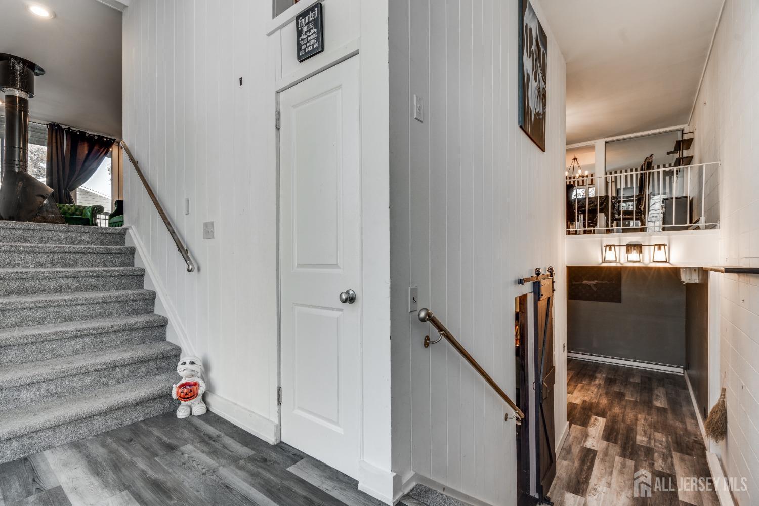 123 Risoli Terrace South Plainfield, NJ 07080 - Photo 27 of 46 a hallway with stairs and wooden floor