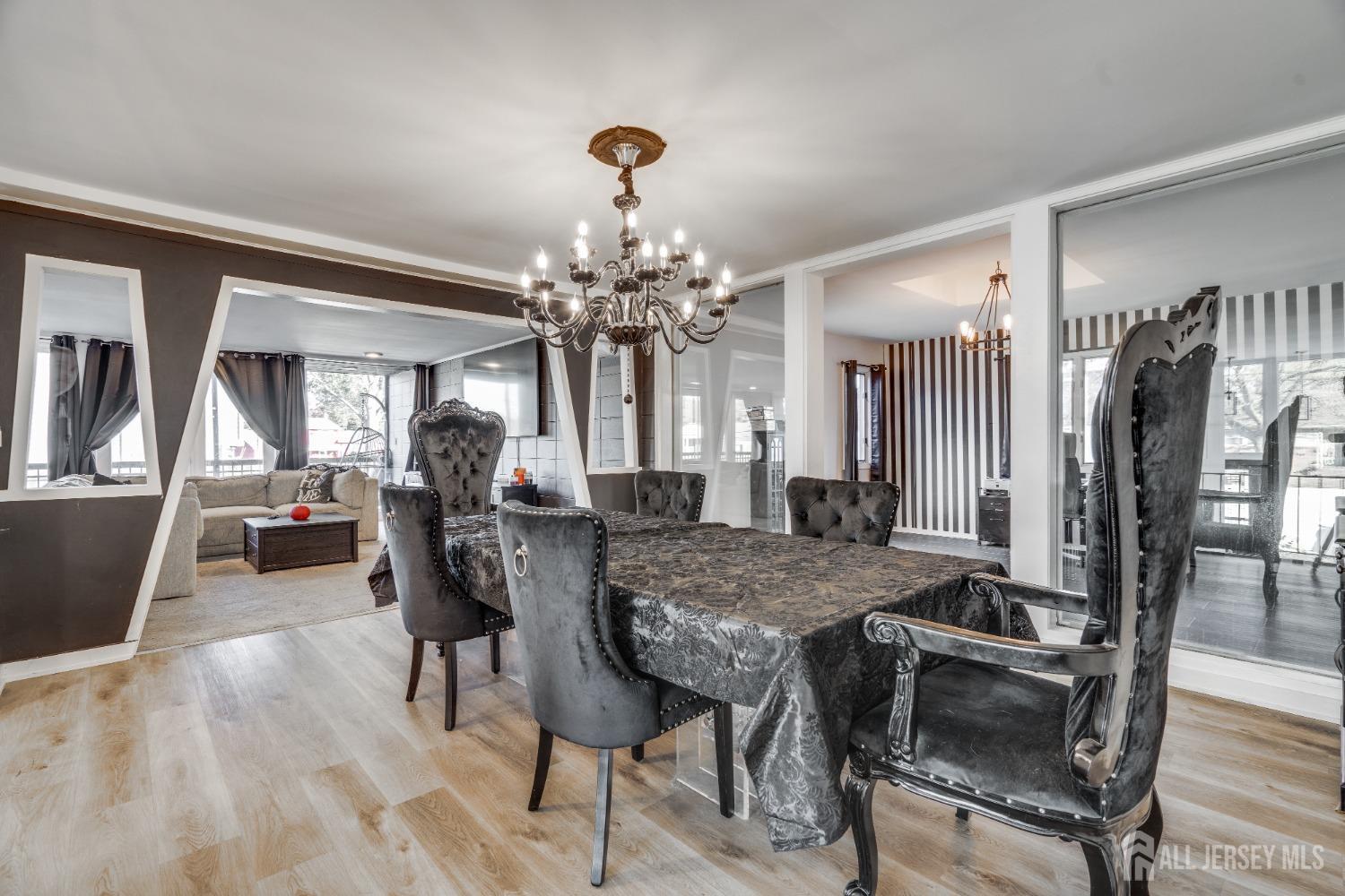 123 Risoli Terrace South Plainfield, NJ 07080 - Photo 31 of 46 a view of a dining room with furniture and a chandelier