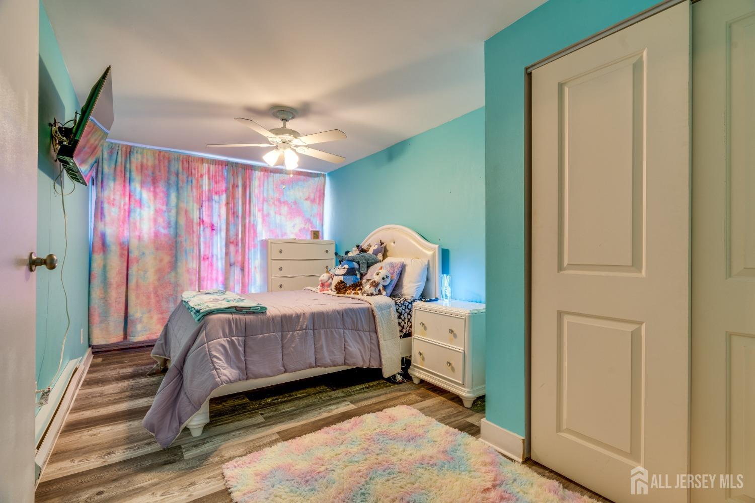 123 Risoli Terrace South Plainfield, NJ 07080 - Photo 43 of 46 a bed room with a bed and a chandelier