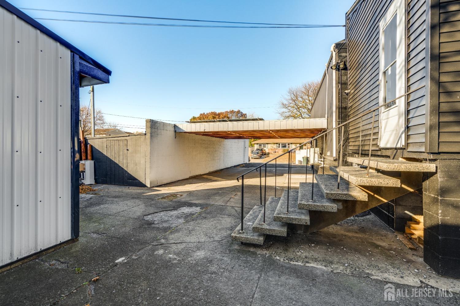 123 Risoli Terrace South Plainfield, NJ 07080 - Photo 8 of 46 a view of a patio with table and chairs