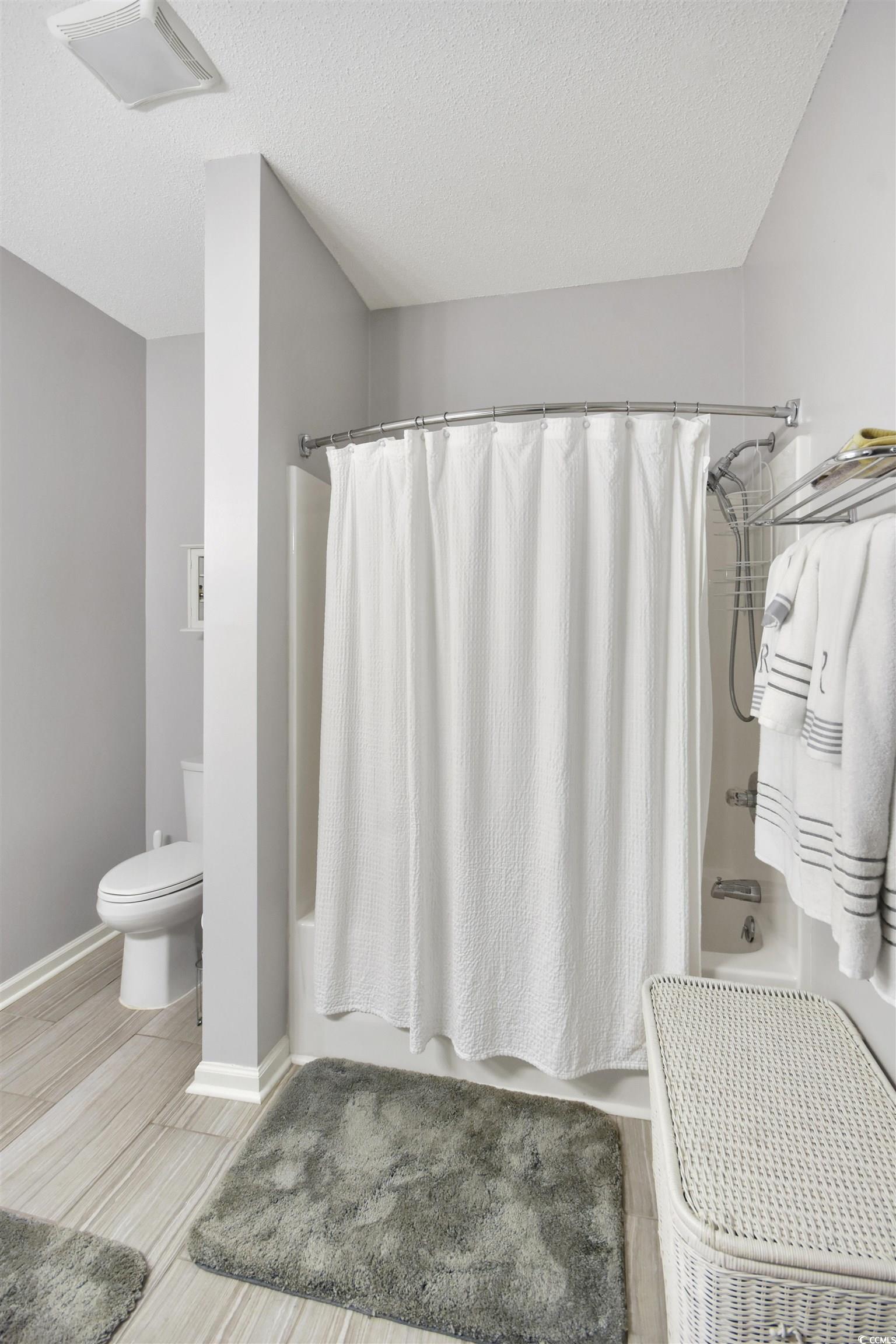 4502 Sweetwater Boulevard, Unit 4502 Murrells Inlet, SC 29576 - Photo 13 of 28 Full bathroom with shower / bath combo and a textured ceiling