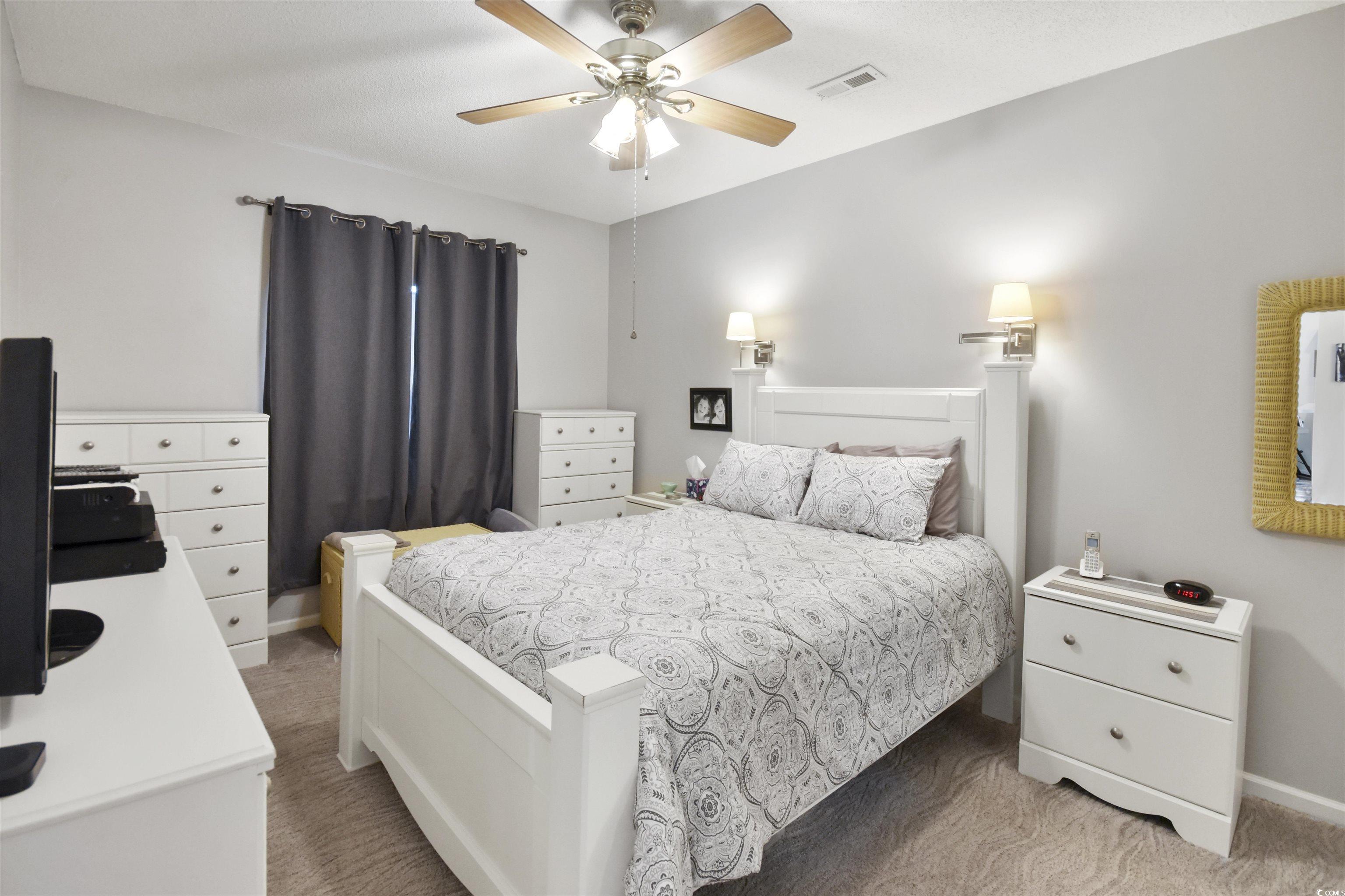 4502 Sweetwater Boulevard, Unit 4502 Murrells Inlet, SC 29576 - Photo 14 of 28 Bedroom with light colored carpet and ceiling fan