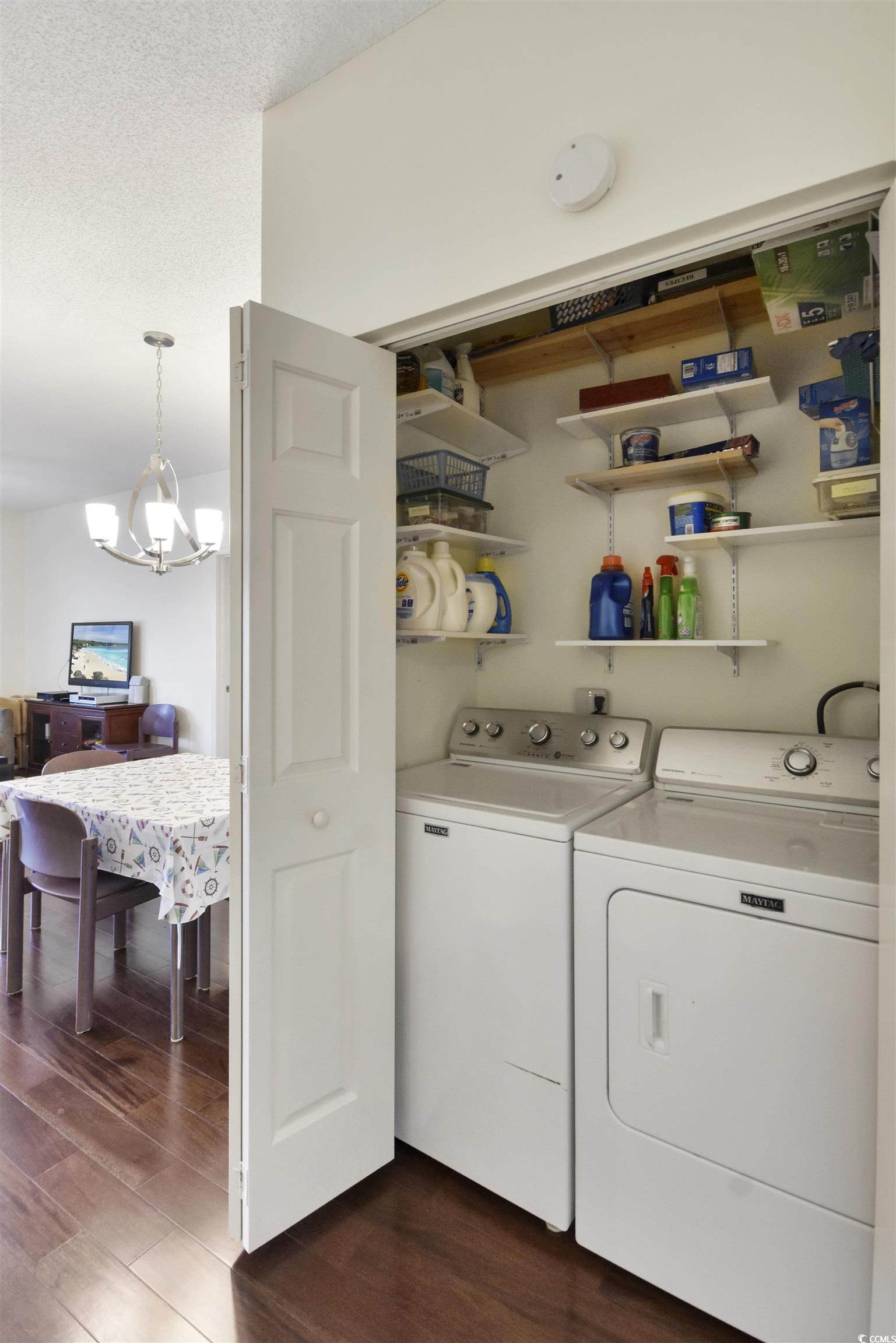 4502 Sweetwater Boulevard, Unit 4502 Murrells Inlet, SC 29576 - Photo 21 of 28 Laundry area with dark wood-type flooring, a chandelier, independent washer and dryer, and a textured ceiling
