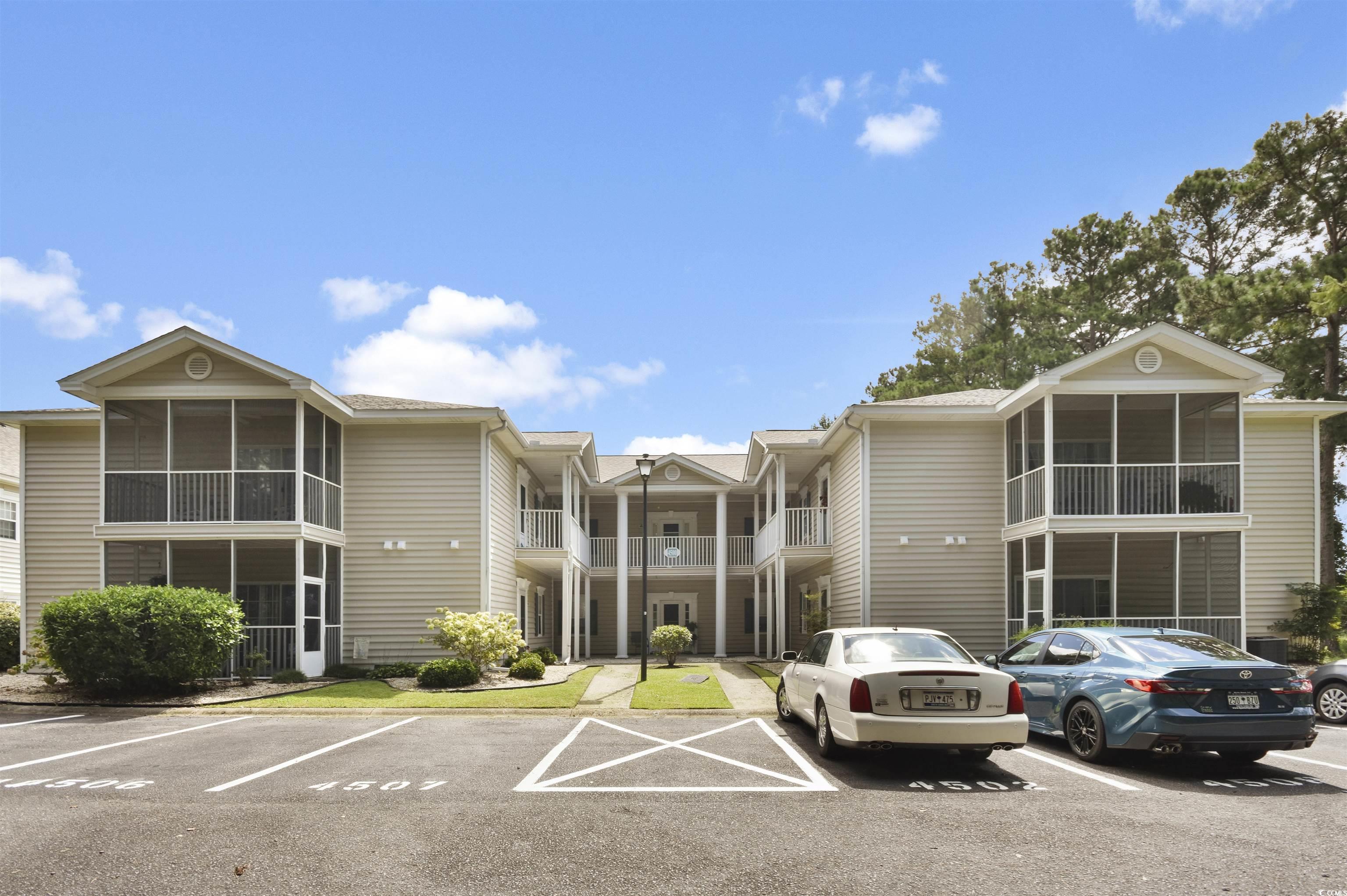 4502 Sweetwater Boulevard, Unit 4502 Murrells Inlet, SC 29576 - Photo 28 of 28 View of building exterior featuring uncovered parking