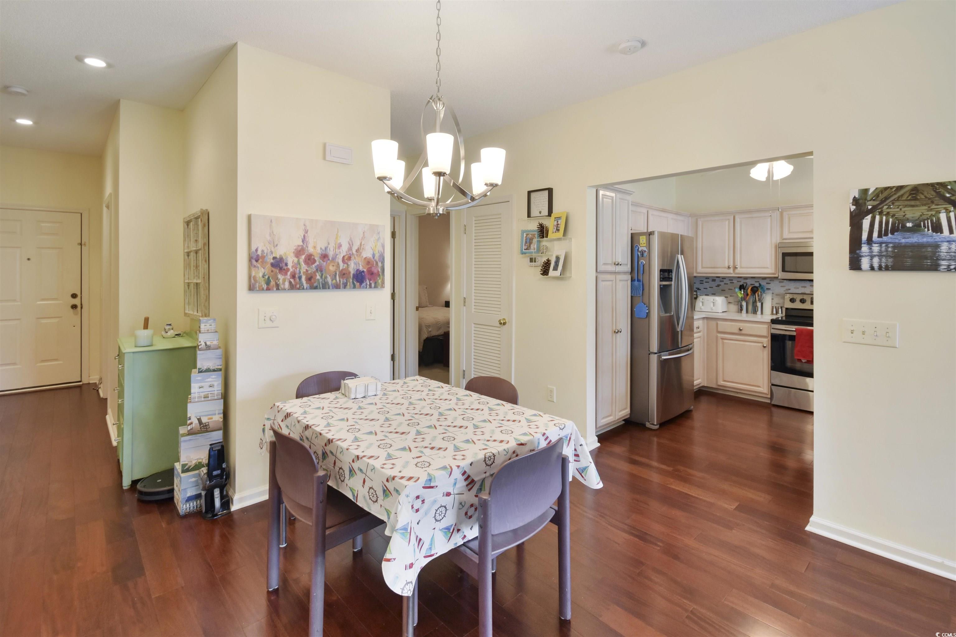 4502 Sweetwater Boulevard, Unit 4502 Murrells Inlet, SC 29576 - Photo 5 of 28 Dining area with dark wood-style floors, recessed lighting, and a chandelier
