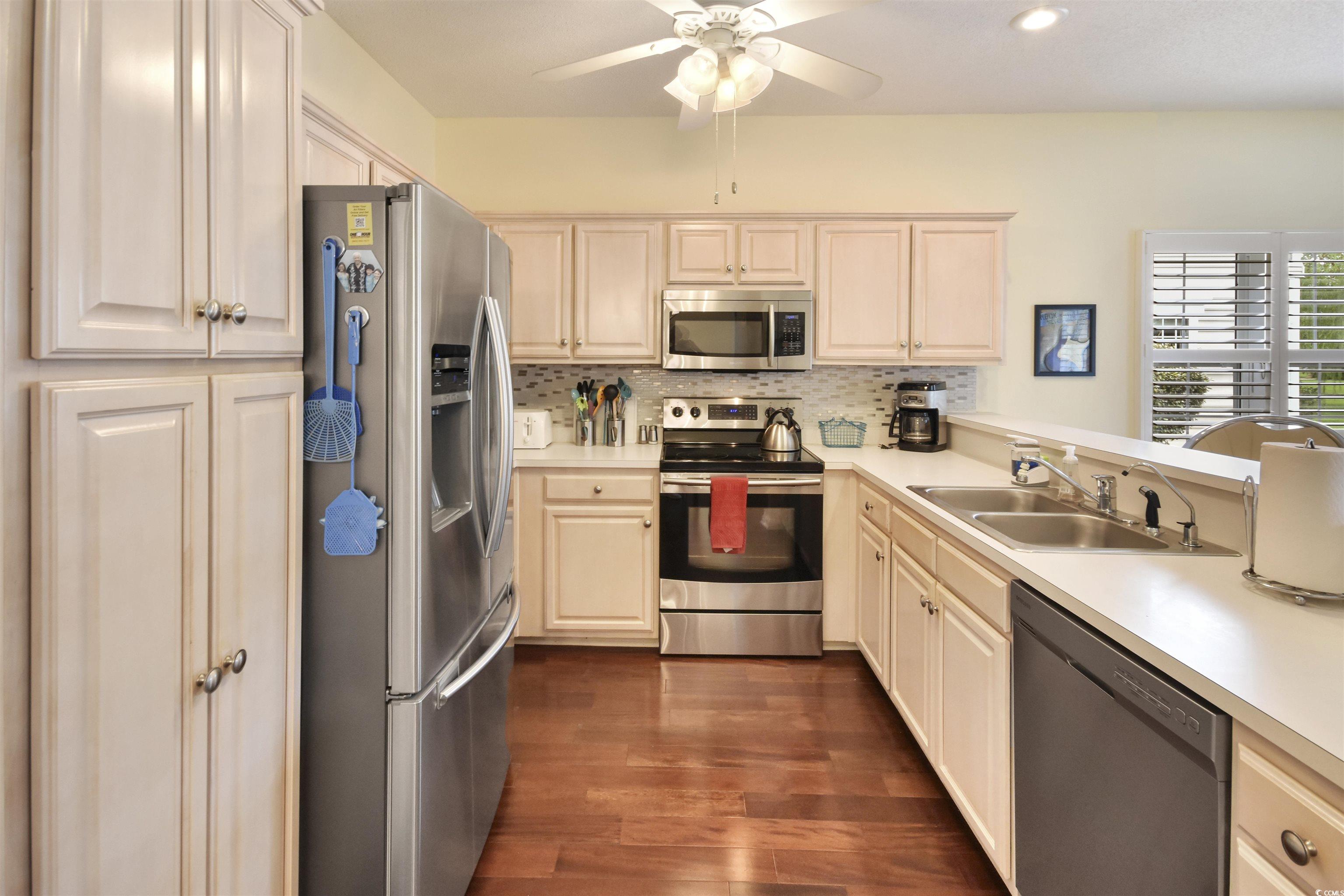 4502 Sweetwater Boulevard, Unit 4502 Murrells Inlet, SC 29576 - Photo 7 of 28 Kitchen featuring stainless steel appliances, light countertops, decorative backsplash, dark wood-type flooring, and recessed lighting