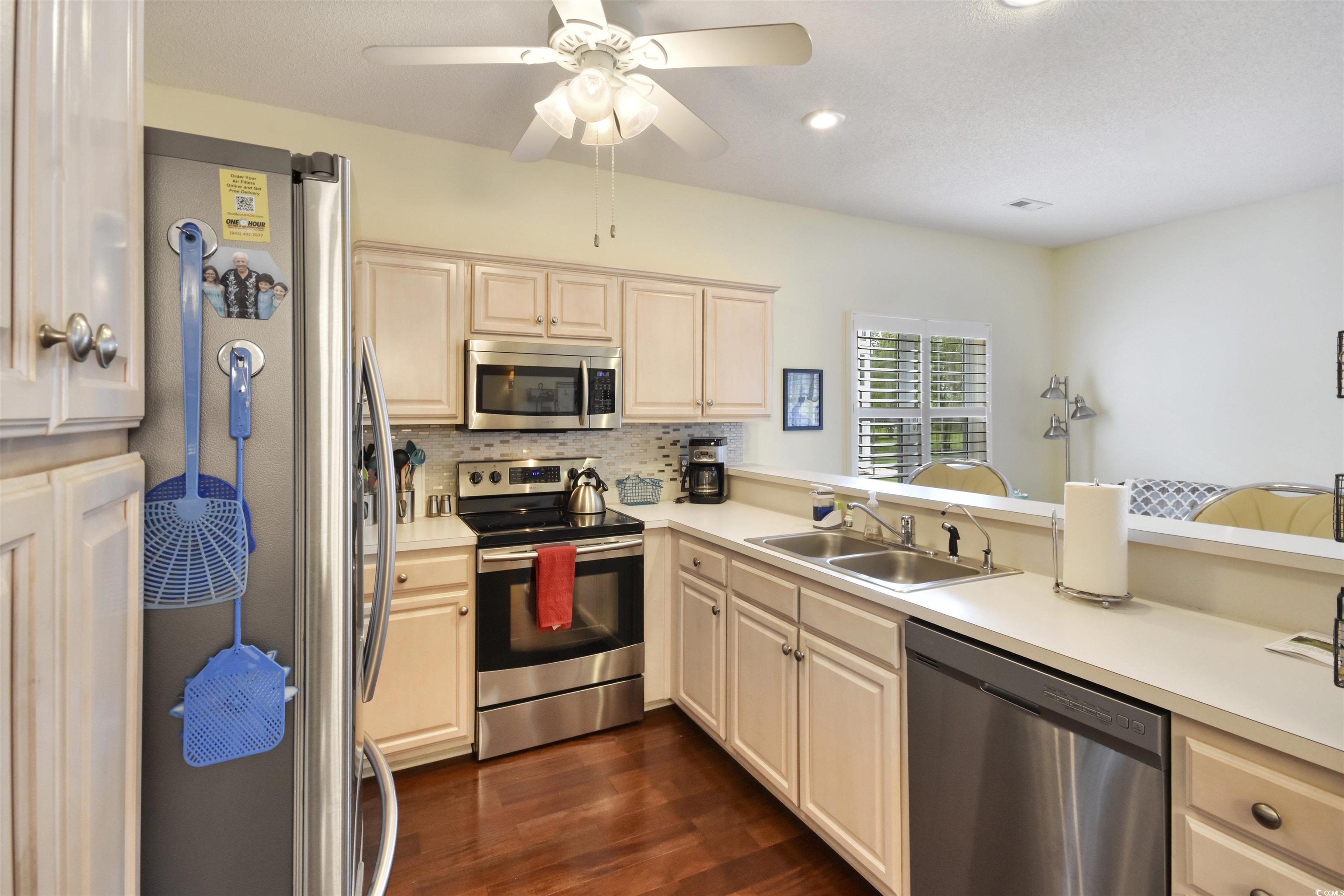 4502 Sweetwater Boulevard, Unit 4502 Murrells Inlet, SC 29576 - Photo 9 of 28 Kitchen featuring appliances with stainless steel finishes, light countertops, dark wood finished floors, decorative backsplash, and recessed lighting
