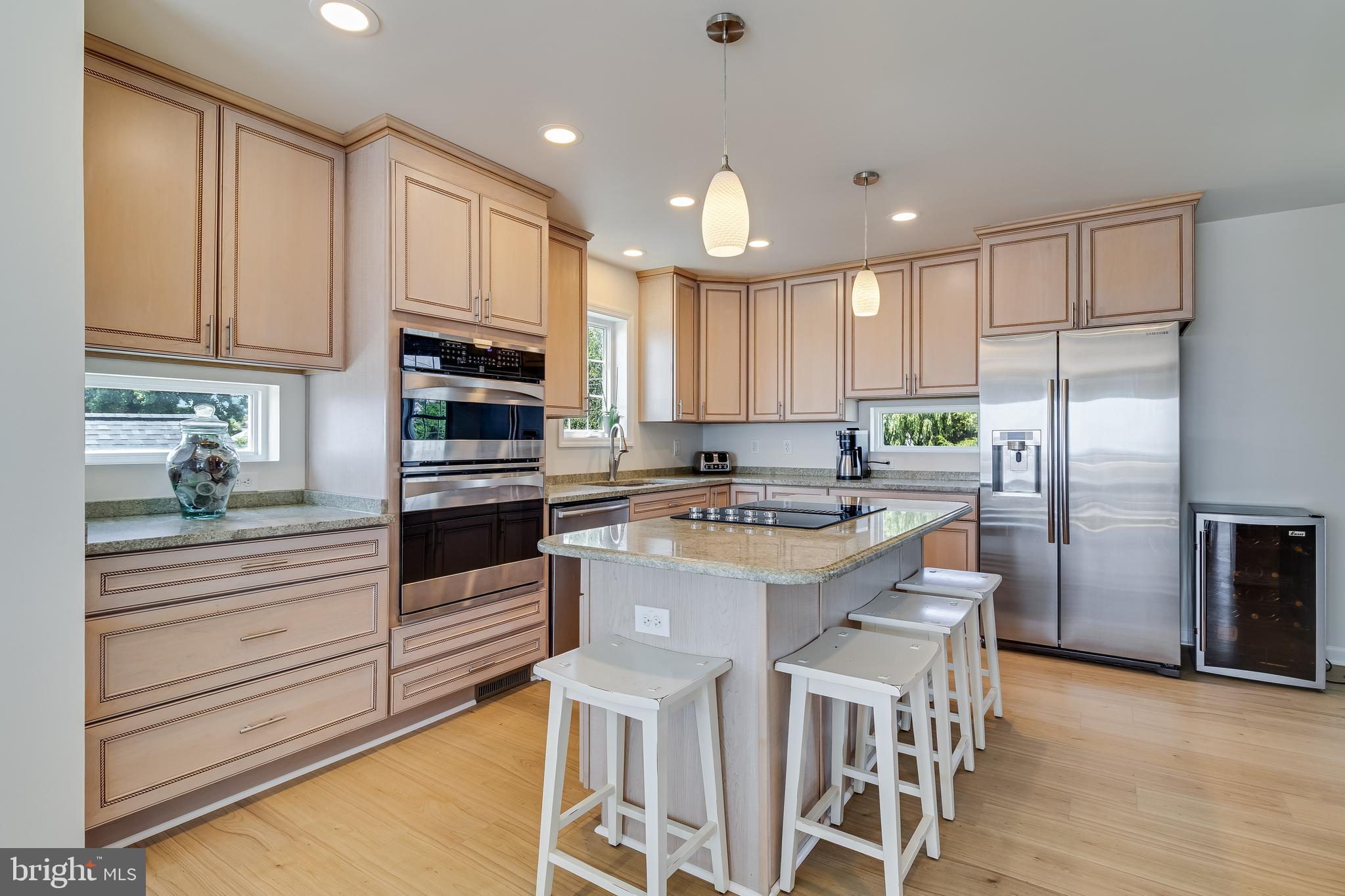 2818 Beach Drive Huntingtown, MD 20639 - Photo 12 of 74 a kitchen with kitchen island granite countertop a stove a sink and a refrigerator