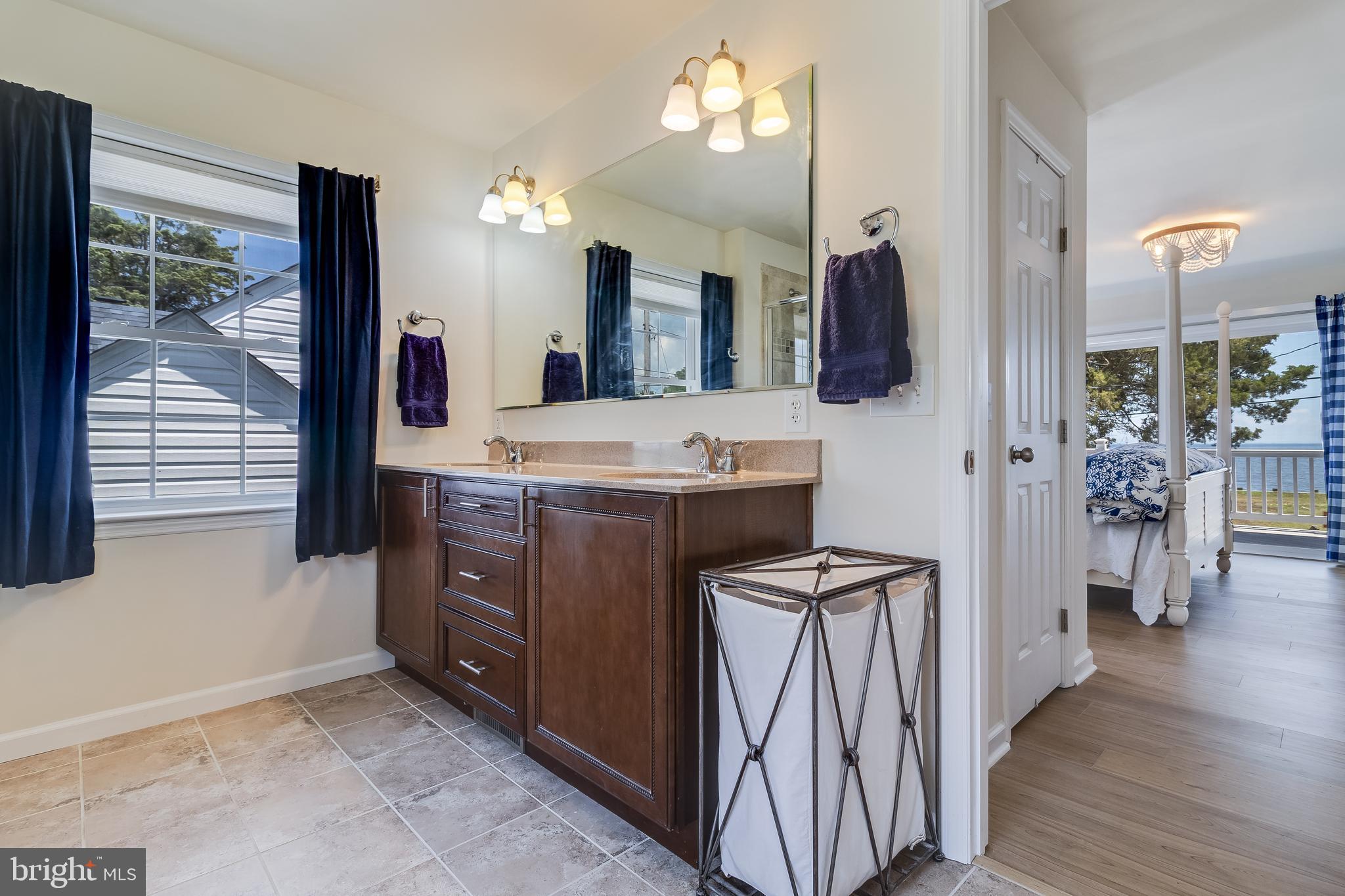 2818 Beach Drive Huntingtown, MD 20639 - Photo 26 of 74 a bathroom with a sink a vanity and a mirror