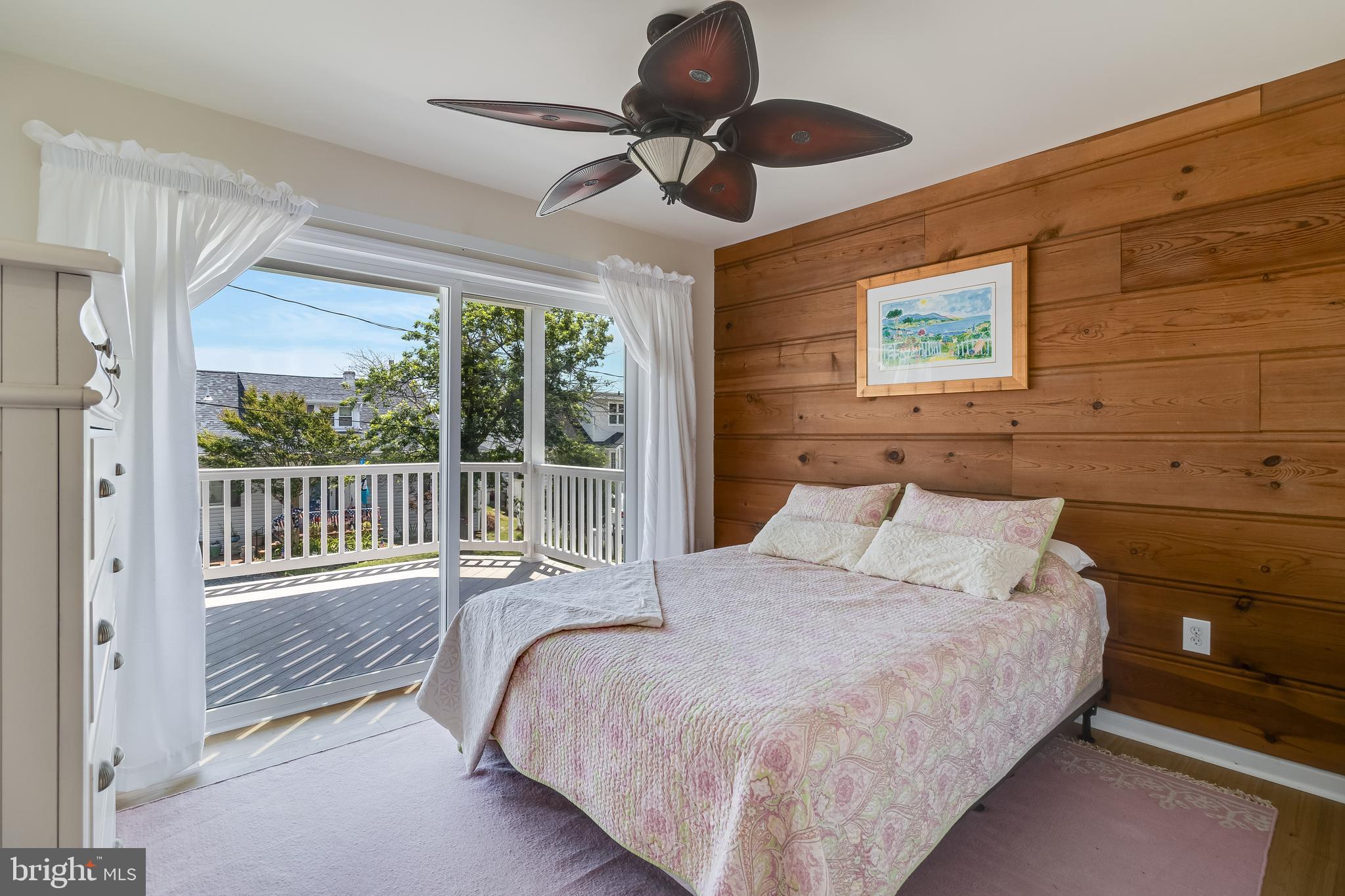 2818 Beach Drive Huntingtown, MD 20639 - Photo 33 of 74 a bedroom with a bed and a chandelier